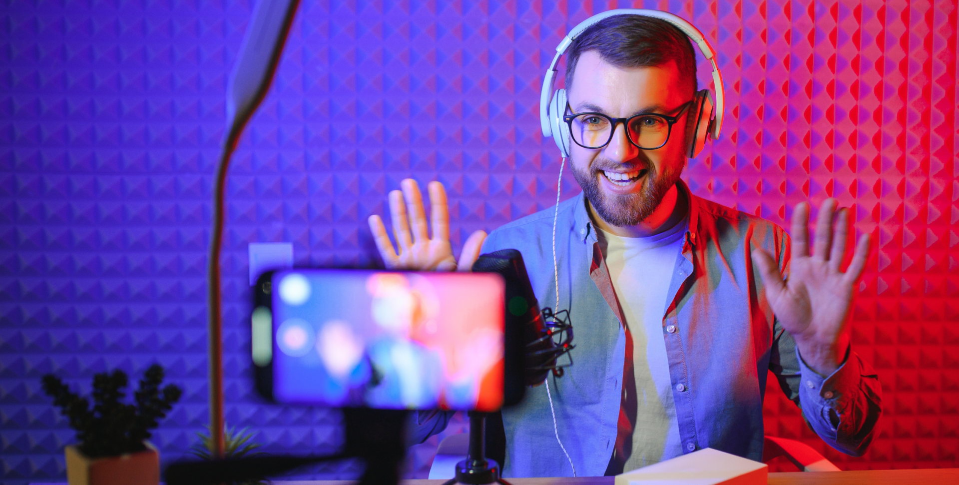 young man recording streaming podcast using microphone his small broadcast studio content creator